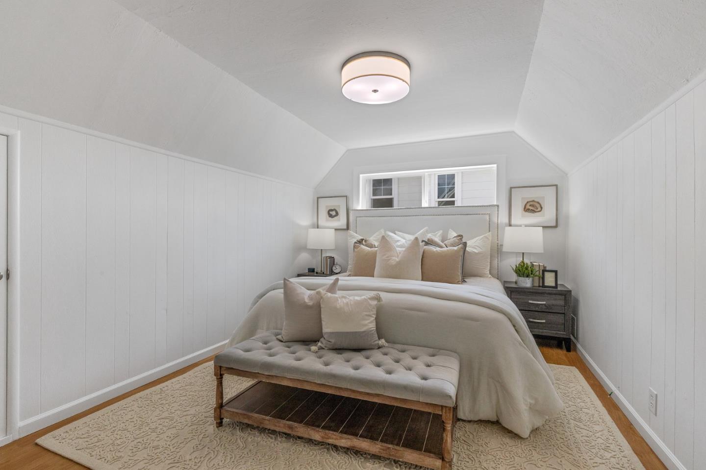 551 Inverness Drive Pacifica, CA 94044 - Photo 25 of 37 a bedroom with a bed and a lamp