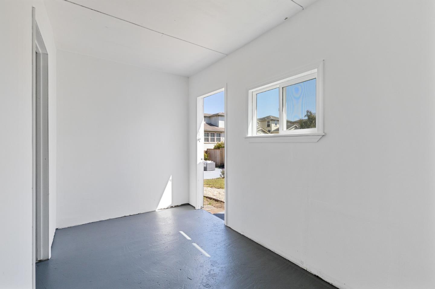 551 Inverness Drive Pacifica, CA 94044 - Photo 31 of 37 a view of an empty room with wooden floor and a window