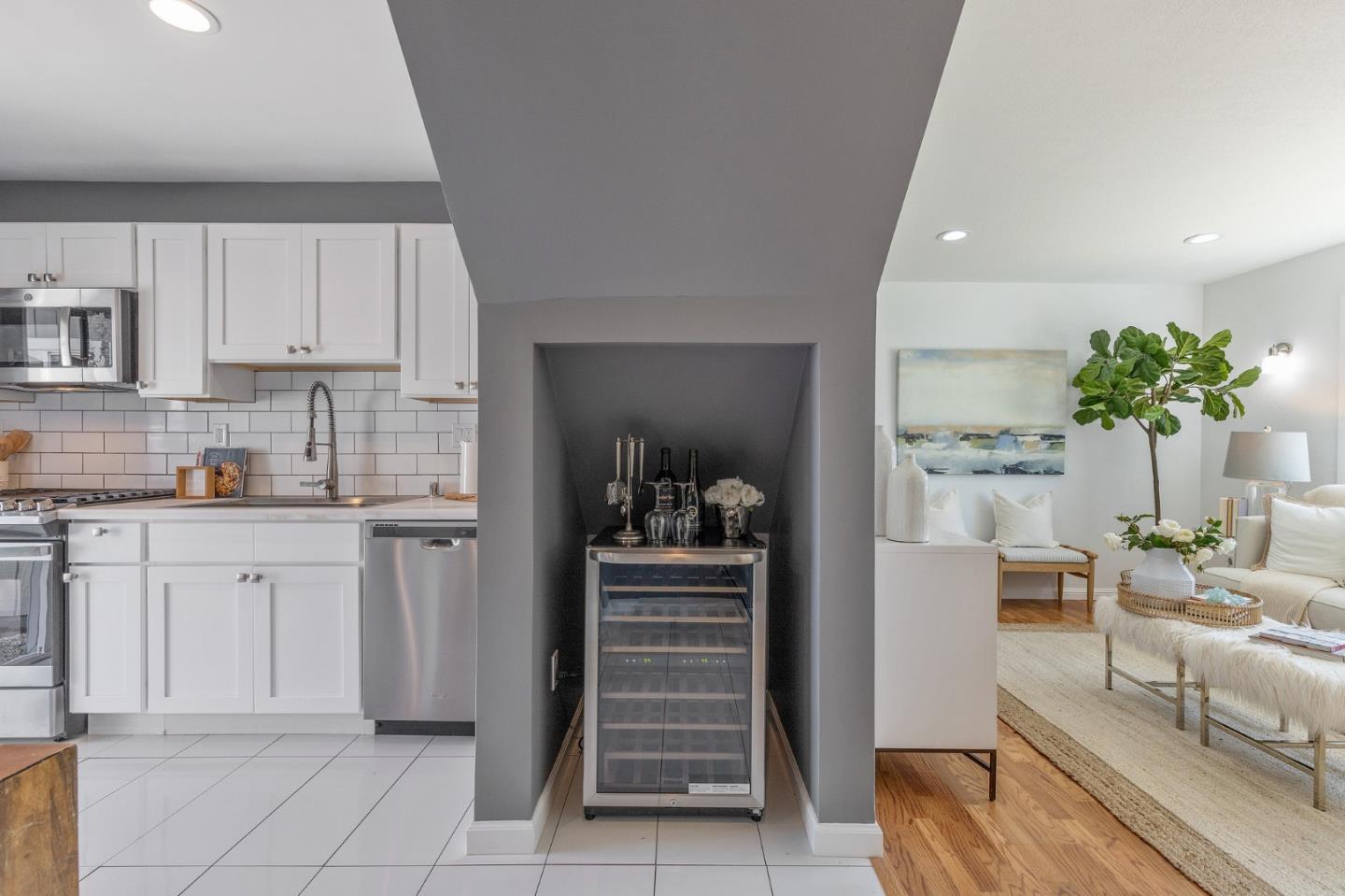 551 Inverness Drive Pacifica, CA 94044 - Photo 10 of 37 a kitchen with granite countertop a refrigerator and white cabinets