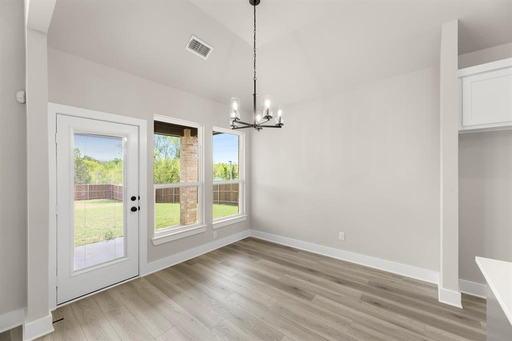 941 Gold Finch Lane Forney, TX 75126 - Photo 13 of 27 a view of empty room with wooden floor and fan