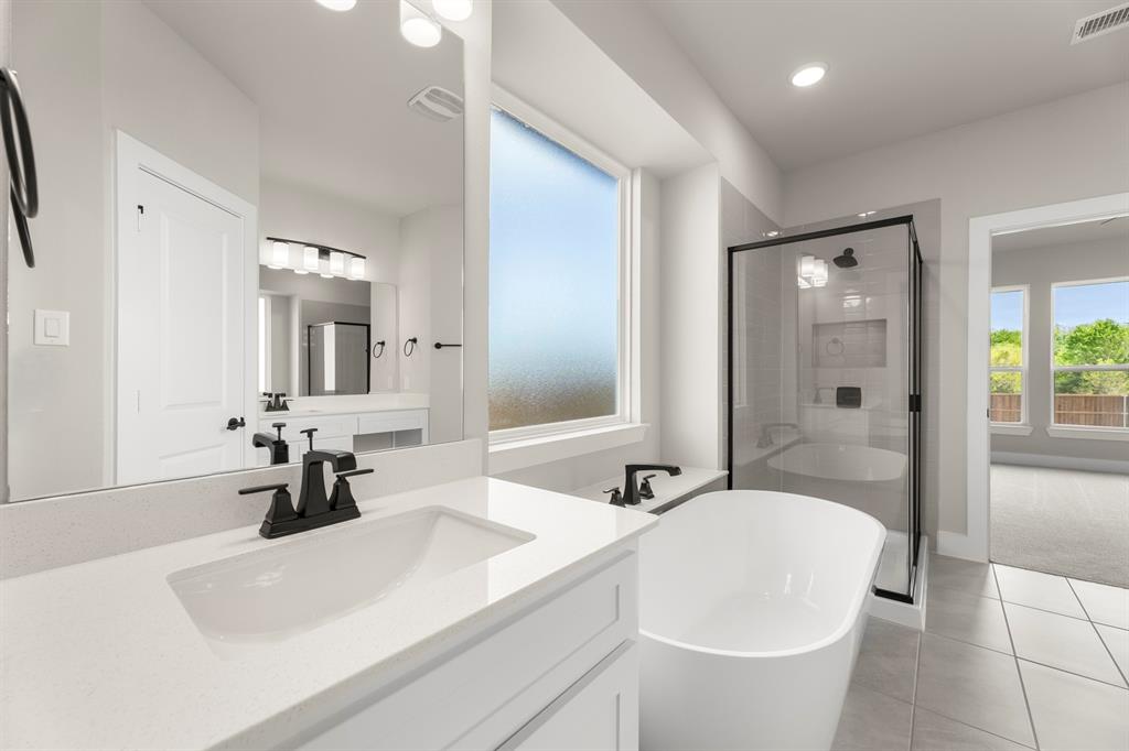 941 Gold Finch Lane Forney, TX 75126 - Photo 19 of 27 a bathroom with a sink a toilet and shower