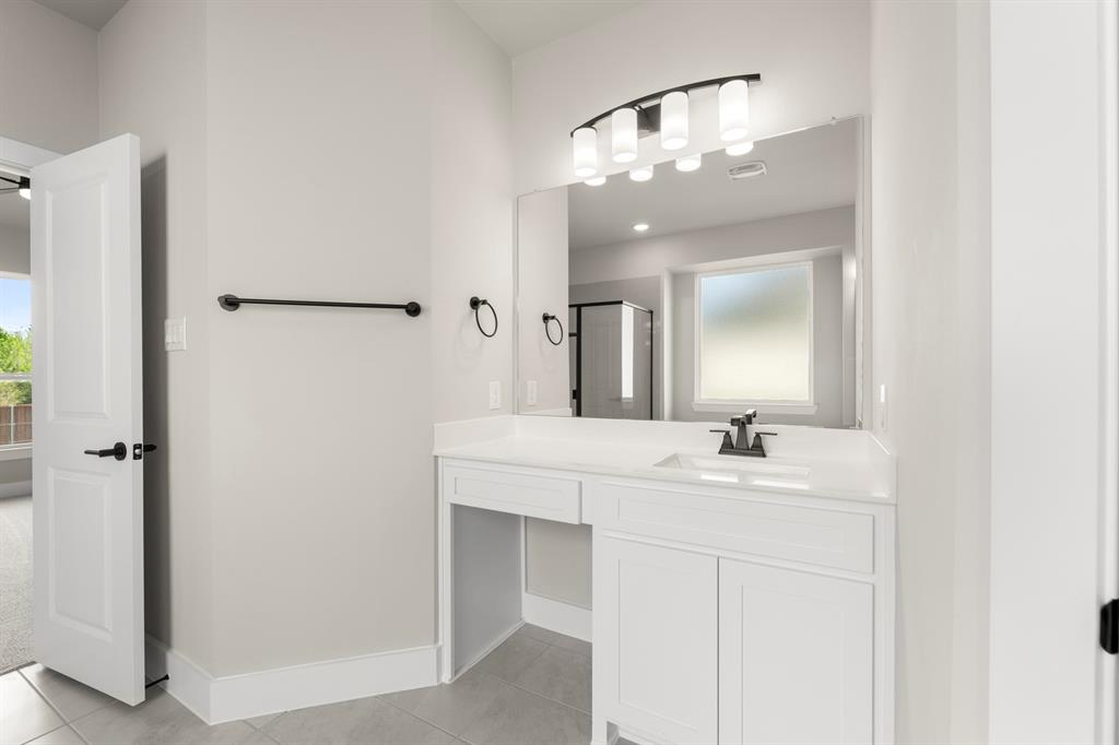 941 Gold Finch Lane Forney, TX 75126 - Photo 20 of 27 a bathroom with a sink and a mirror