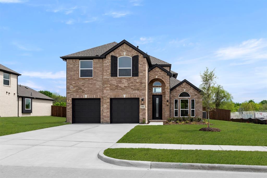 941 Gold Finch Lane Forney, TX 75126 - Photo 2 of 27 a front view of a house with a garden