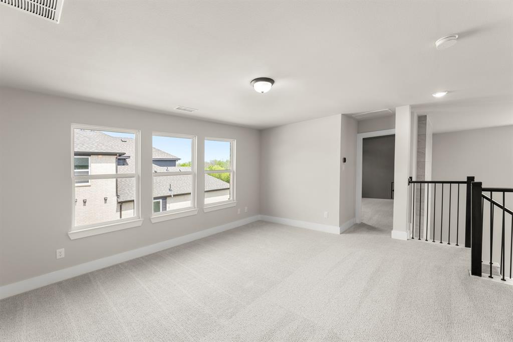 941 Gold Finch Lane Forney, TX 75126 - Photo 22 of 27 wooden floor in an empty room with a window