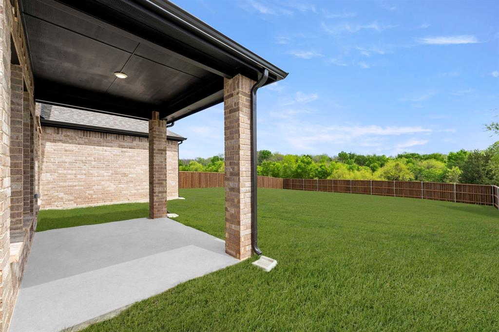 941 Gold Finch Lane Forney, TX 75126 - Photo 25 of 27 a view of a porch and garden