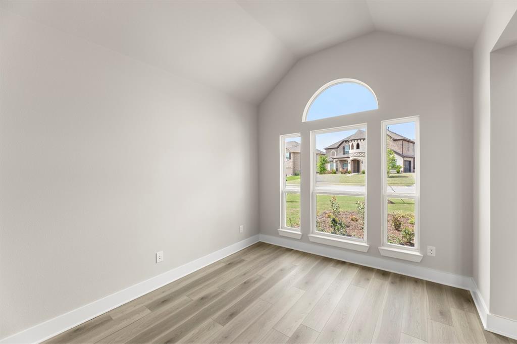 941 Gold Finch Lane Forney, TX 75126 - Photo 5 of 27 an empty room with wooden floor and window