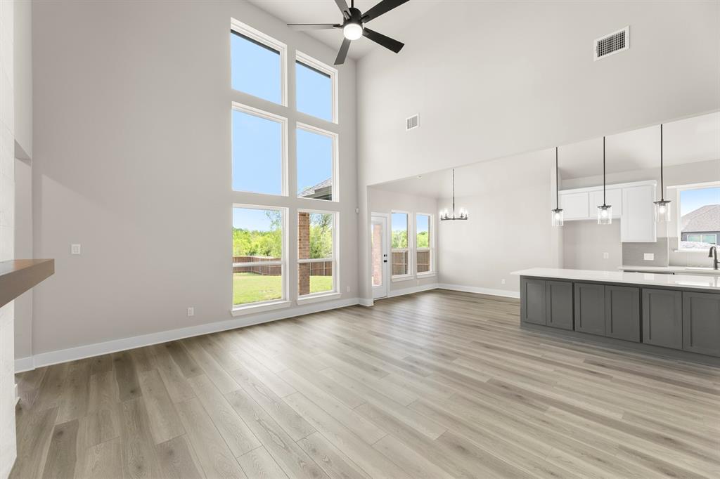 941 Gold Finch Lane Forney, TX 75126 - Photo 7 of 27 a view of wooden floor and windows in a room