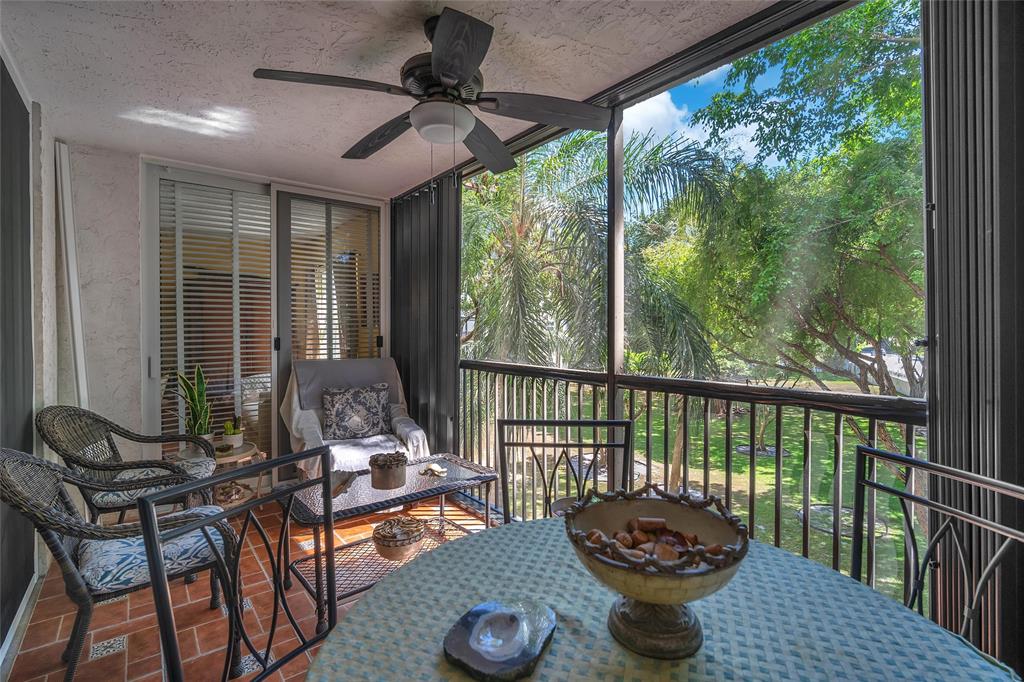 3910 Inverrary Boulevard, Unit 308B Lauderhill, FL 33319 - Photo 26 of 53 a living room with furniture and a floor to ceiling window