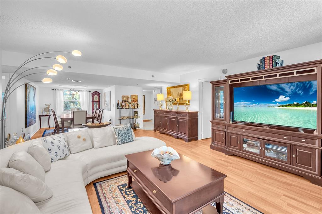 3910 Inverrary Boulevard, Unit 308B Lauderhill, FL 33319 - Photo 28 of 53 a living room with furniture and a flat screen tv