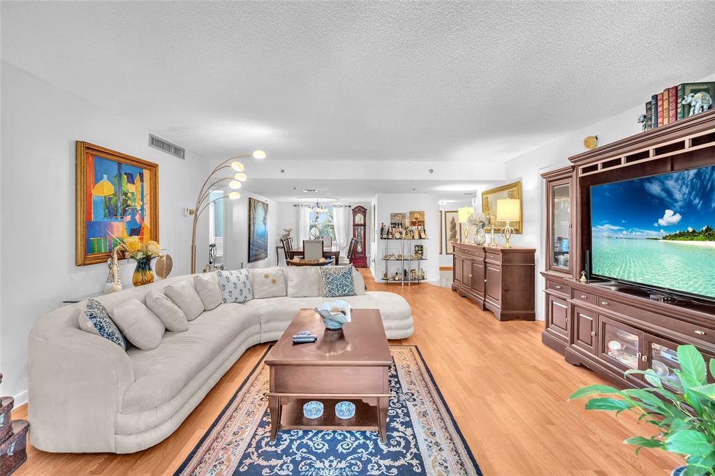 3910 Inverrary Boulevard, Unit 308B Lauderhill, FL 33319 - Photo 6 of 53 a living room with furniture and a flat screen tv