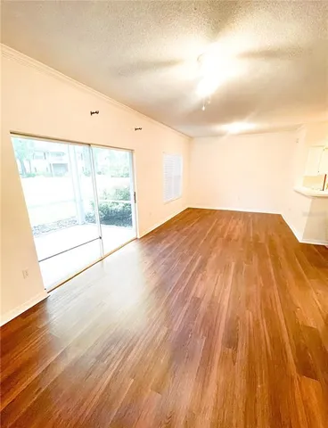 a view of a room with wooden floor