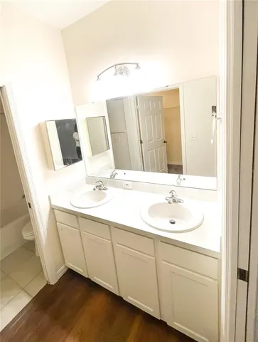 a bathroom with a sink a toilet and a mirror