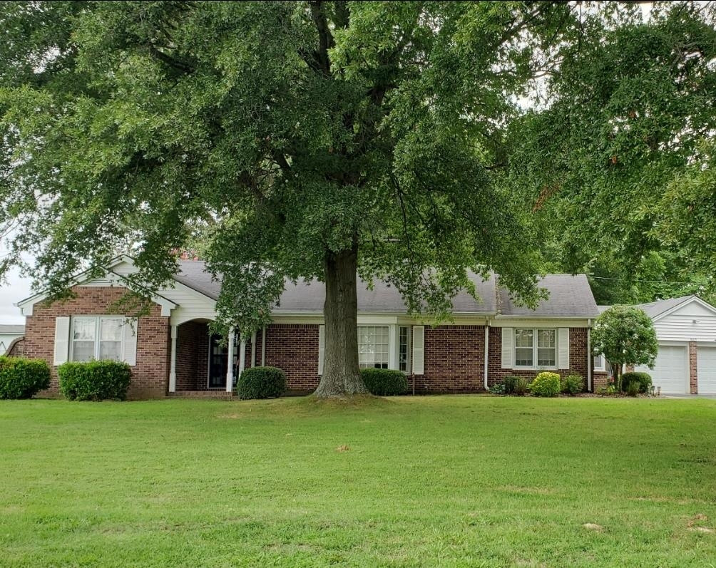 605 South Trenton Street Rutherford, TN 38369 - Photo 1 of 39 a front view of a house with a garden and yard