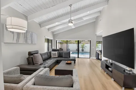 a living room with couches and a potted plant on table