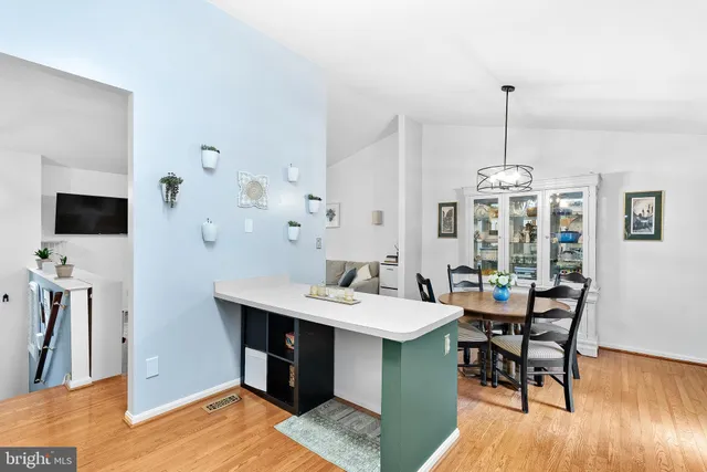 a view of a dining room with furniture wooden floor and a chandelier