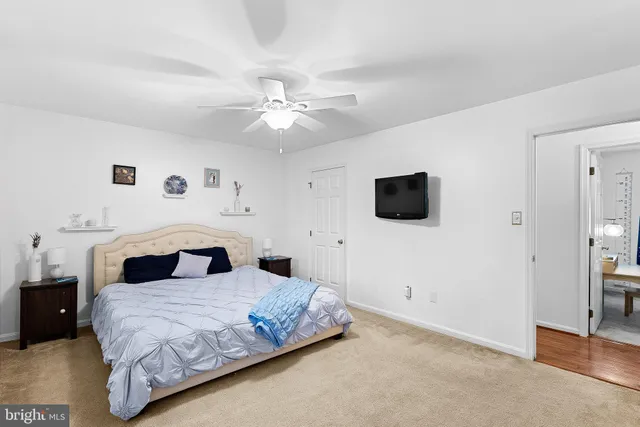 a bedroom with a large bed and a flat screen tv