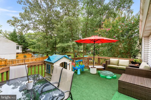 an outdoor sitting area with furniture and garden view
