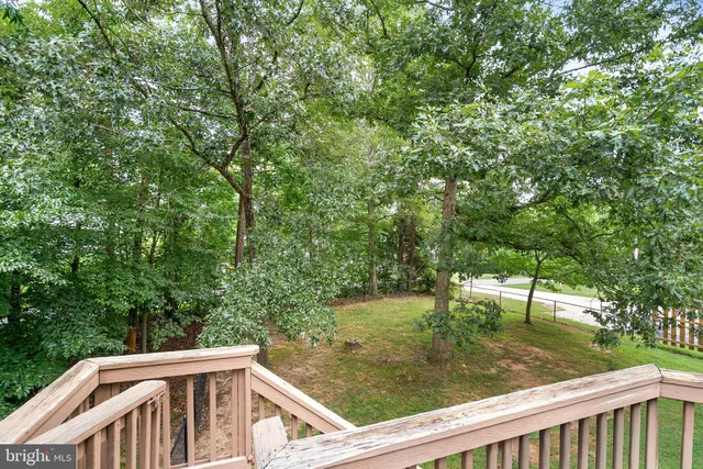 a view of a wooden deck and backyard