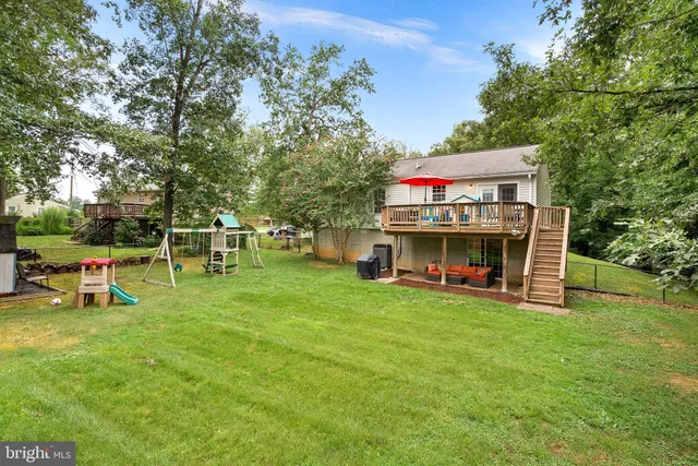 a view of a house with a yard porch and sitting area