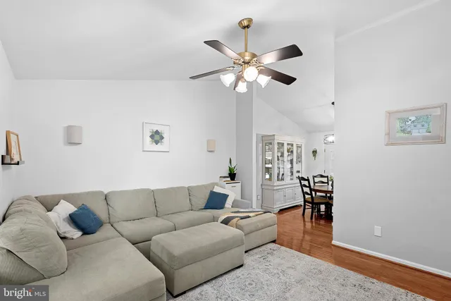 a living room with furniture wooden floor and a window