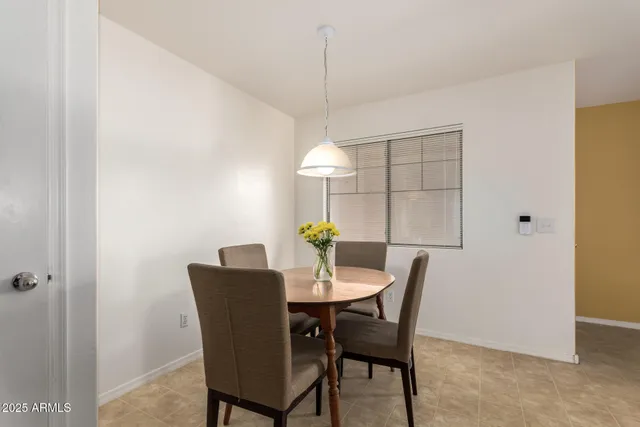 a dining room with furniture and window