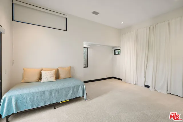 a living room with furniture and a white wall