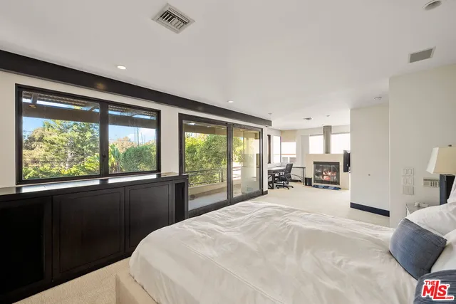 a large bedroom with a large bed and a large window