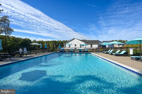 a view of a swimming pool with sitting area