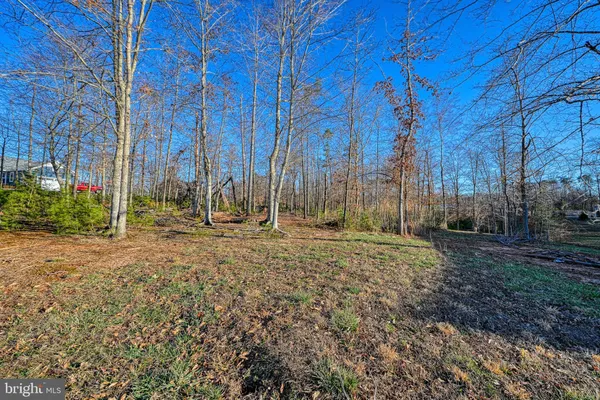 an aerial view of a house with backyard