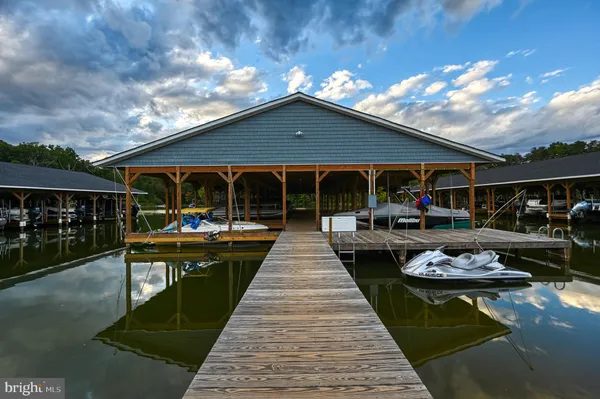a view of a patio with couches table and chairs and potted plants