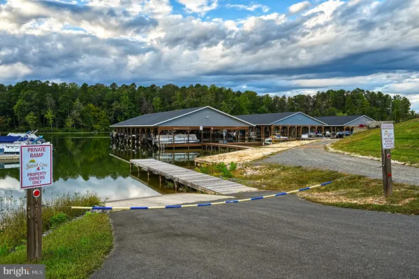 a view of swimming pool with lawn chairs and iron fence