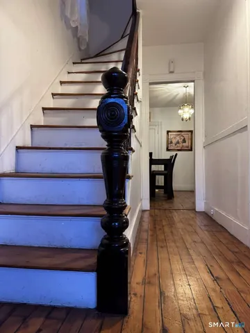 a view of entryway and hall with wooden floor