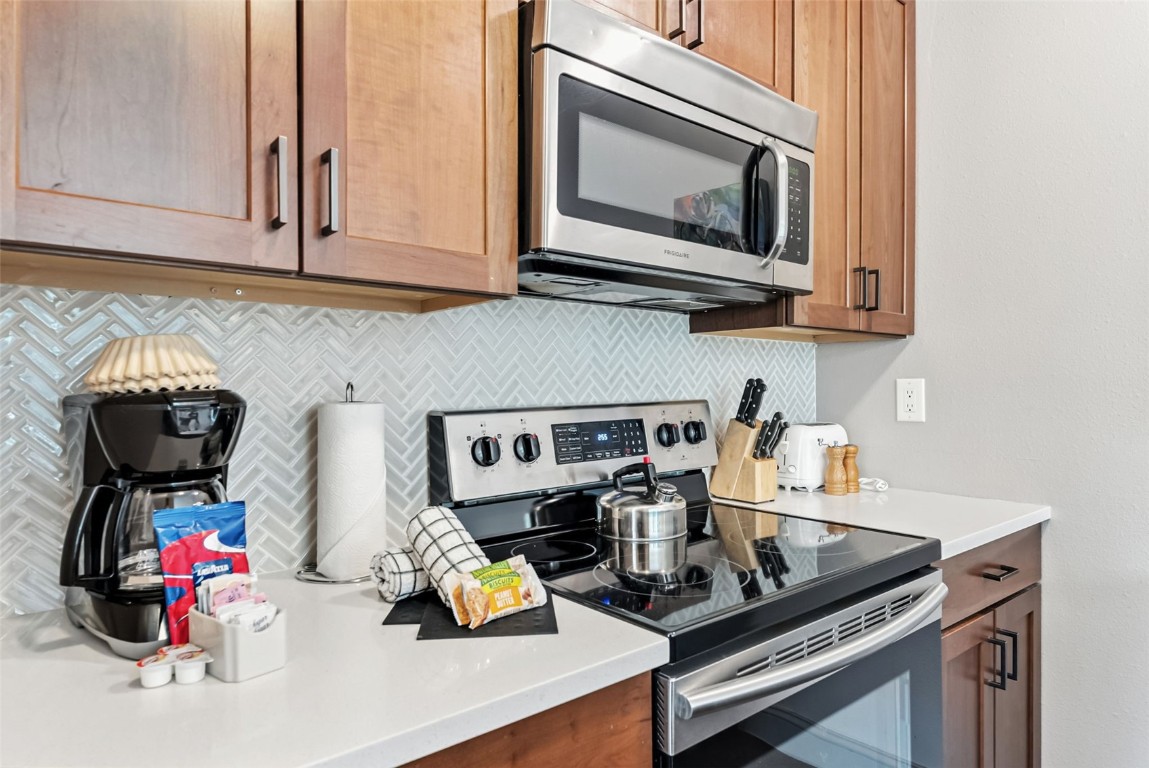 22300 Highway 6, Unit 1745 Keystone, CO 80435 - Photo 15 of 43 a kitchen with a stove a microwave and cabinets