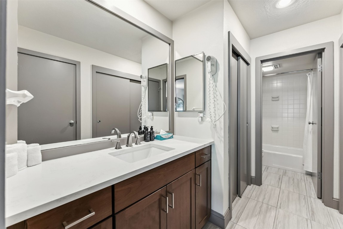 22300 Highway 6, Unit 1745 Keystone, CO 80435 - Photo 27 of 43 a bathroom with a sink a mirror and a shower