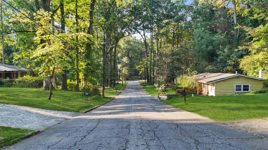 0 Pebble Drive Atlanta, GA 30344 - Photo 7 of 23 a front view of a house with a yard and trees