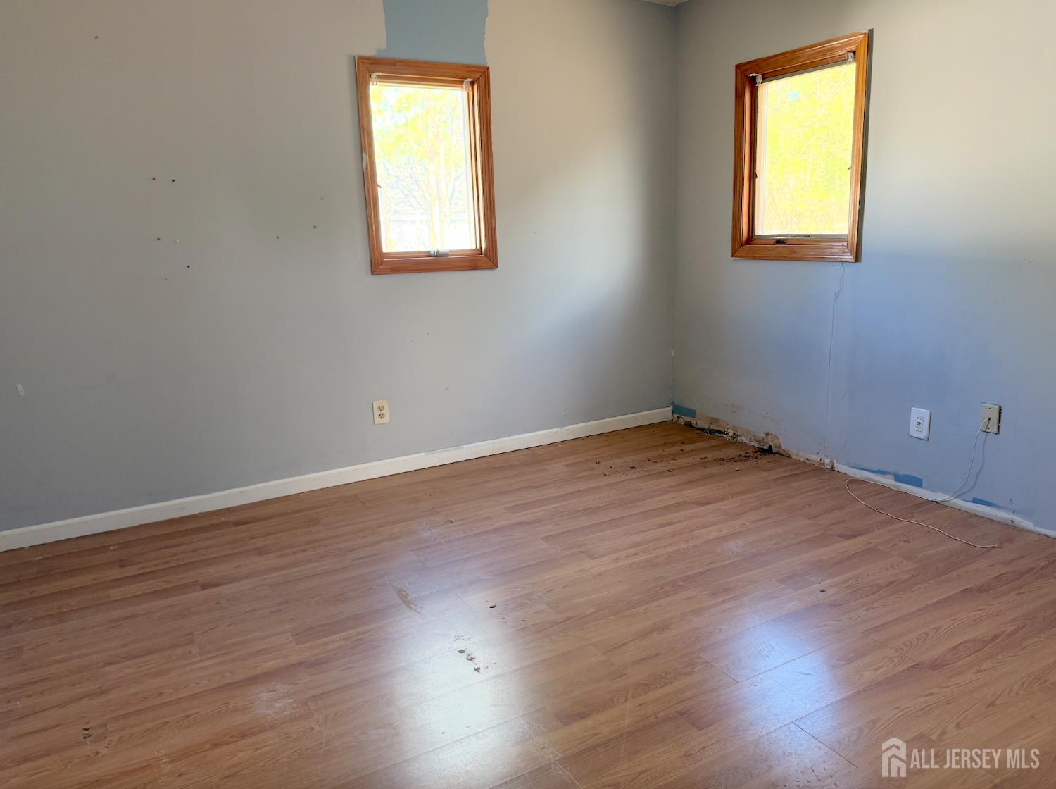 4 Forrestal Road Kendall Park, NJ 08824 - Photo 14 of 22 an empty room with wooden floor and windows