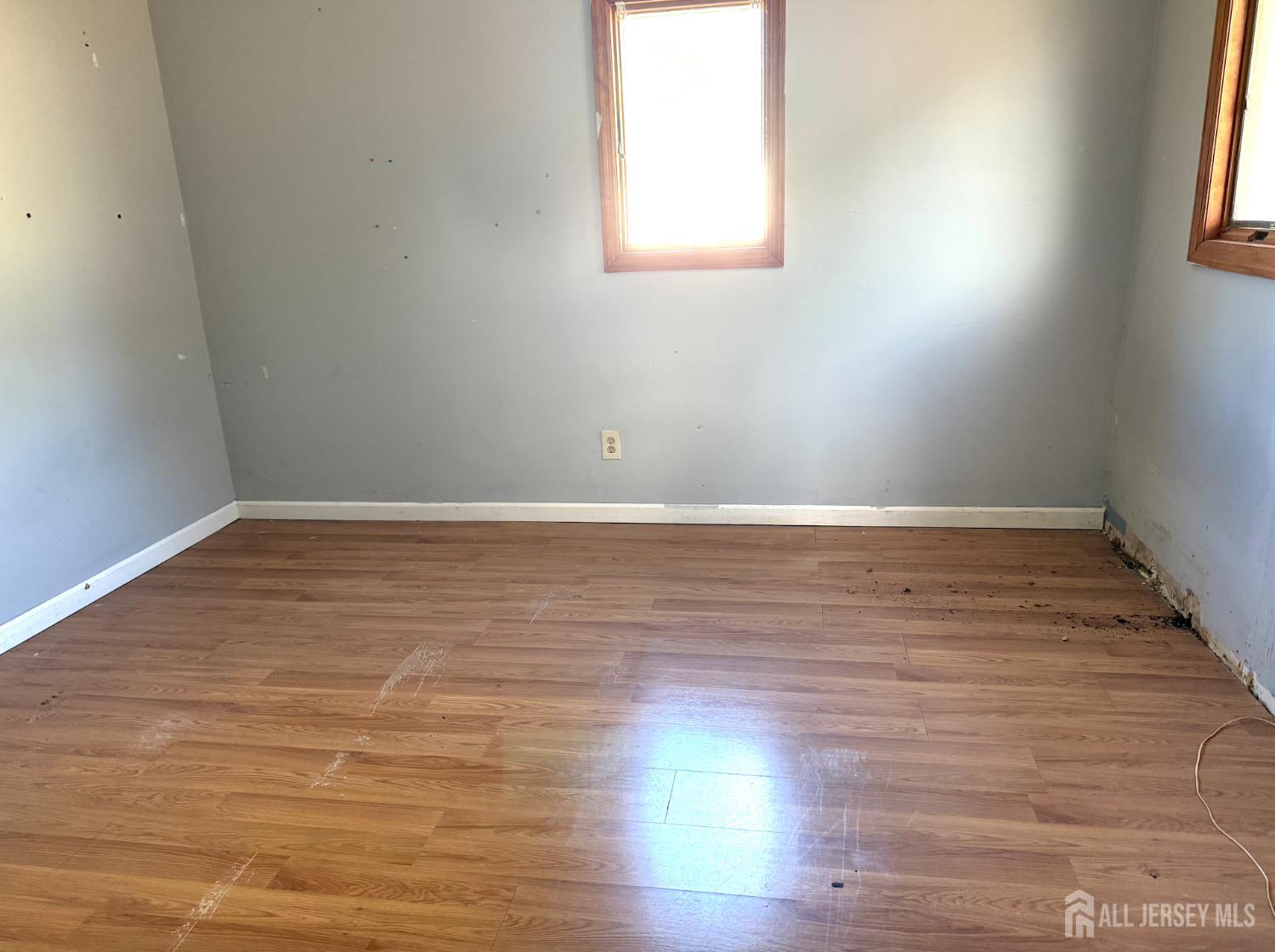 4 Forrestal Road Kendall Park, NJ 08824 - Photo 15 of 22 an empty room with wooden floor and windows