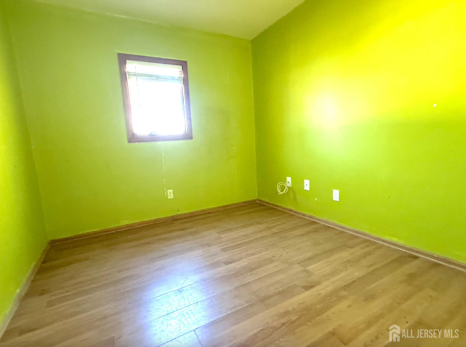 4 Forrestal Road Kendall Park, NJ 08824 - Photo 16 of 22 a view of a big room with wooden floor and windows