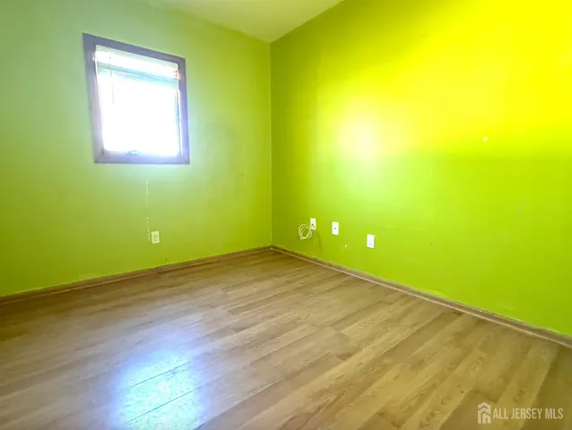 a view of a bedroom with a window and a ceiling fan