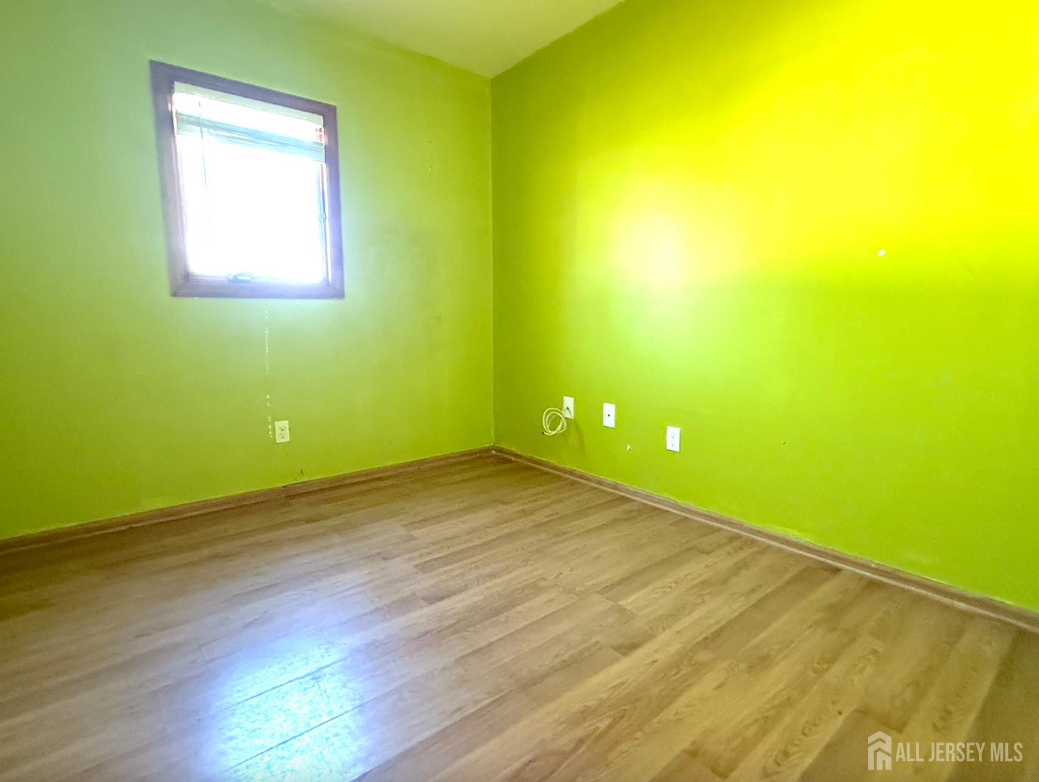 4 Forrestal Road Kendall Park, NJ 08824 - Photo 17 of 22 an empty room with wooden floor and windows
