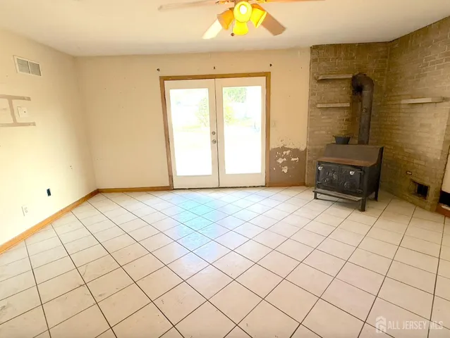 a kitchen with stainless steel appliances granite countertop a stove top oven a sink a dining table and chairs