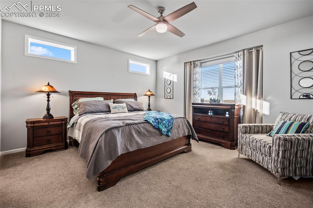 9393 North Log Road Calhan, CO 80808 - Photo 26 of 49 a bedroom with a bed and ceiling fan