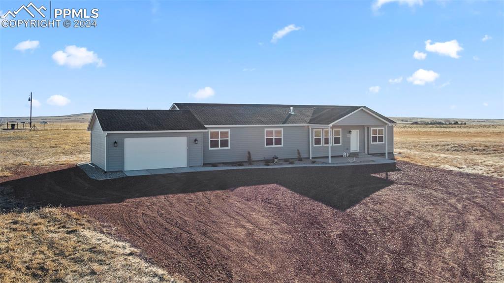 9393 North Log Road Calhan, CO 80808 - Photo 3 of 49 a front view of a house with a yard