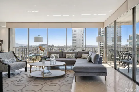 a living room with furniture and a floor to ceiling window