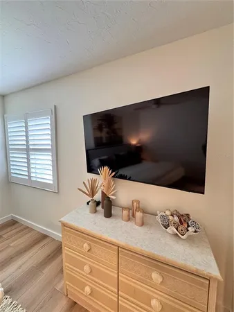 a living room with granite countertop furniture and flat screen tv