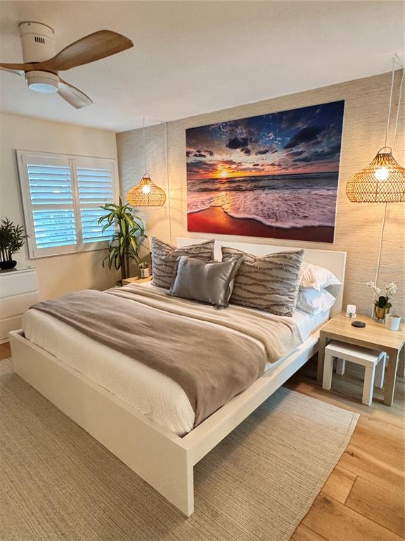 5623 Midnight Pass Road, Unit 615 Siesta Key, FL 34242 - Photo 14 of 21 a bedroom with a bed and a night stand