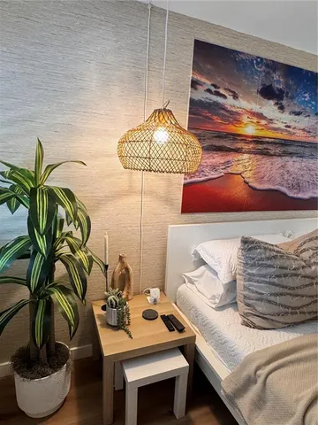 a bathroom with a granite countertop toilet sink and mirror