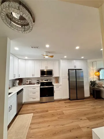 a view of a house with backyard water fountain and a fire pit