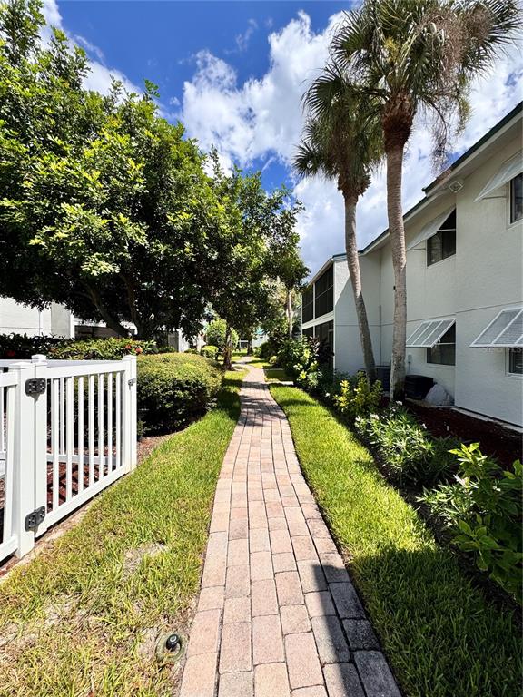 5623 Midnight Pass Road, Unit 615 Siesta Key, FL 34242 - Photo 20 of 21 a view of a pathway with a yard