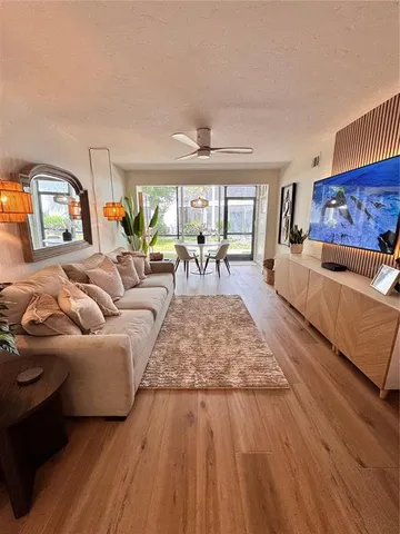 a living room with furniture and a wooden floor